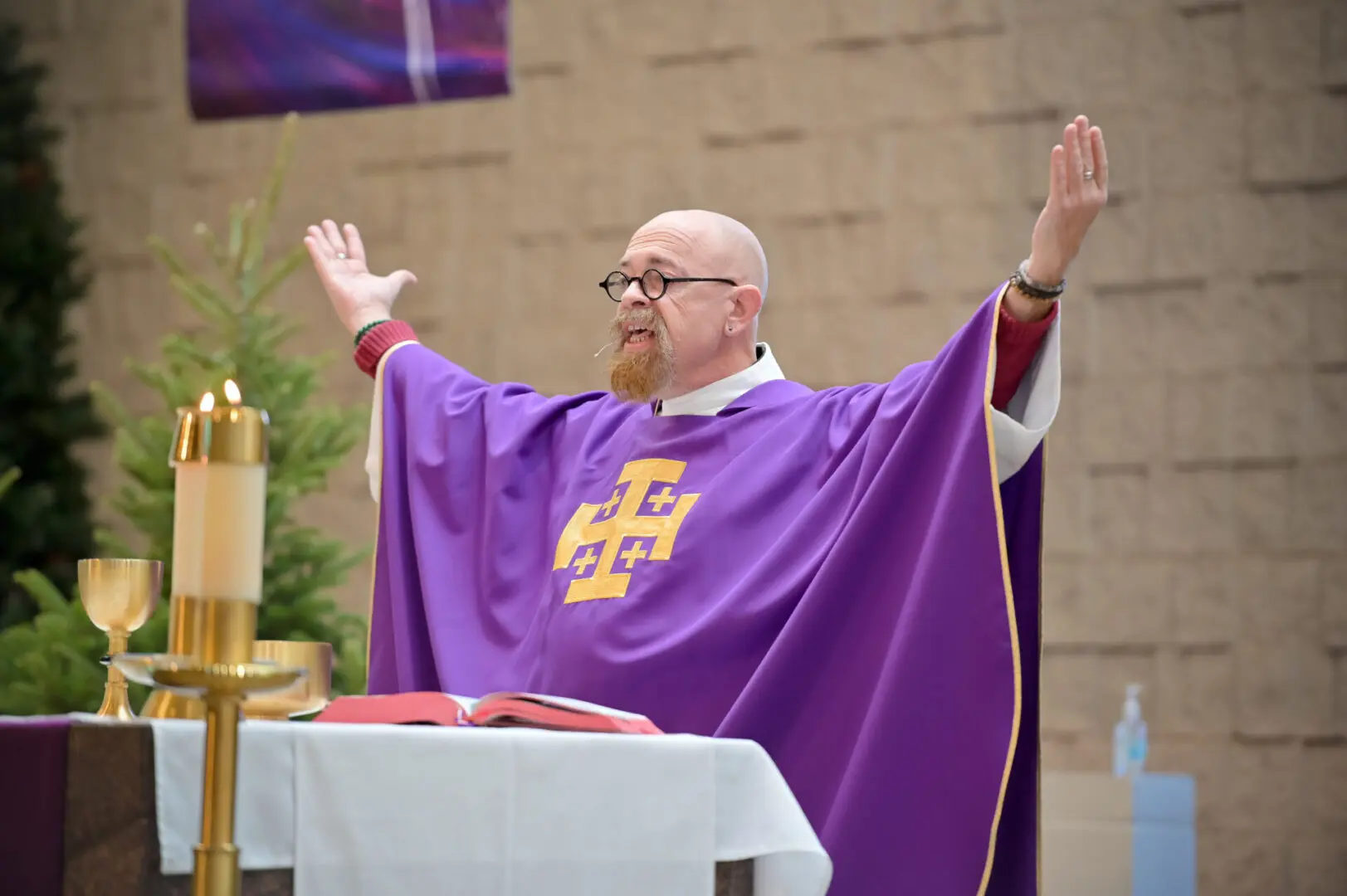 Man in purple robe giving a sermon.