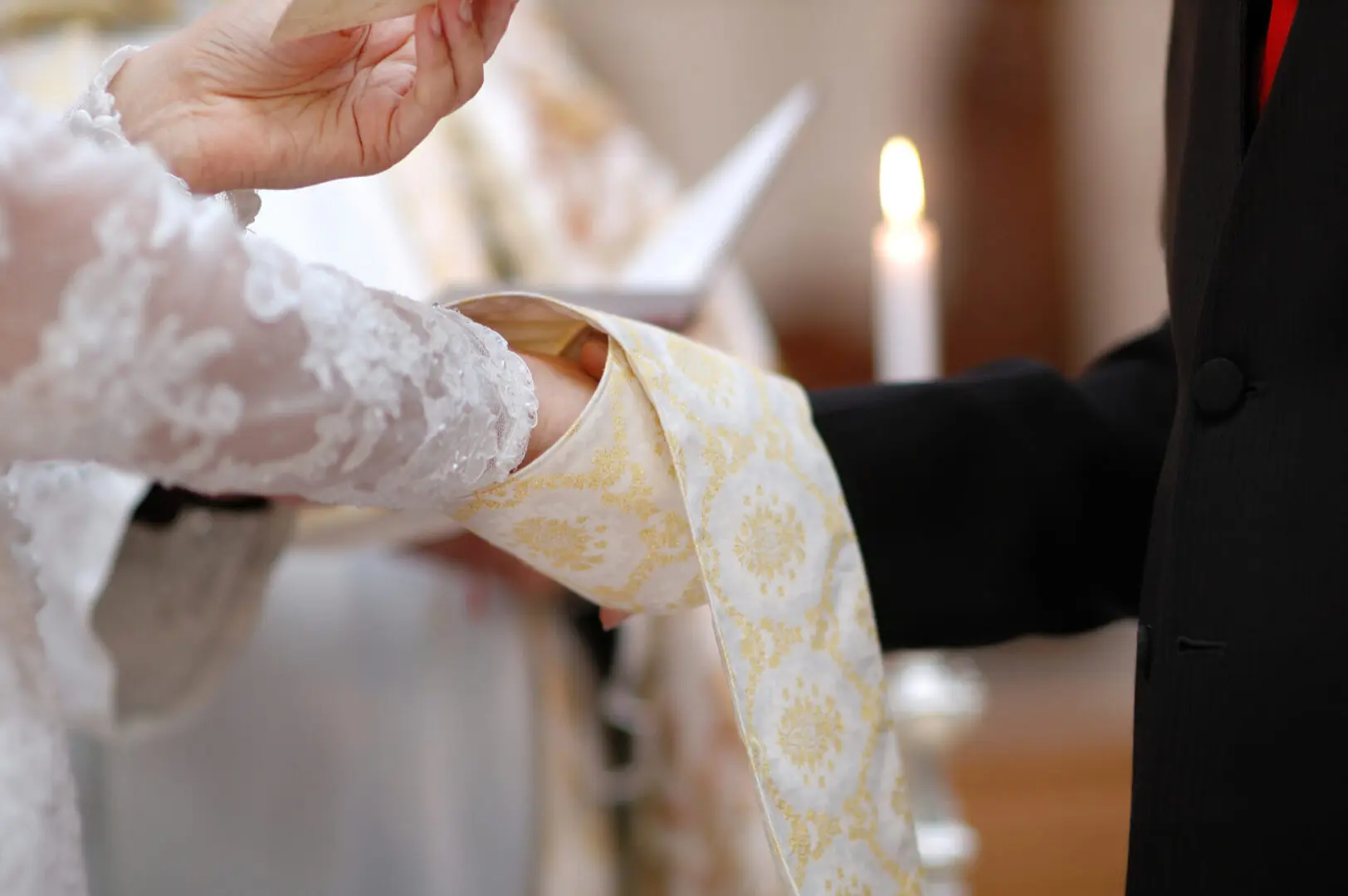 Bride and groom holding hands at wedding.