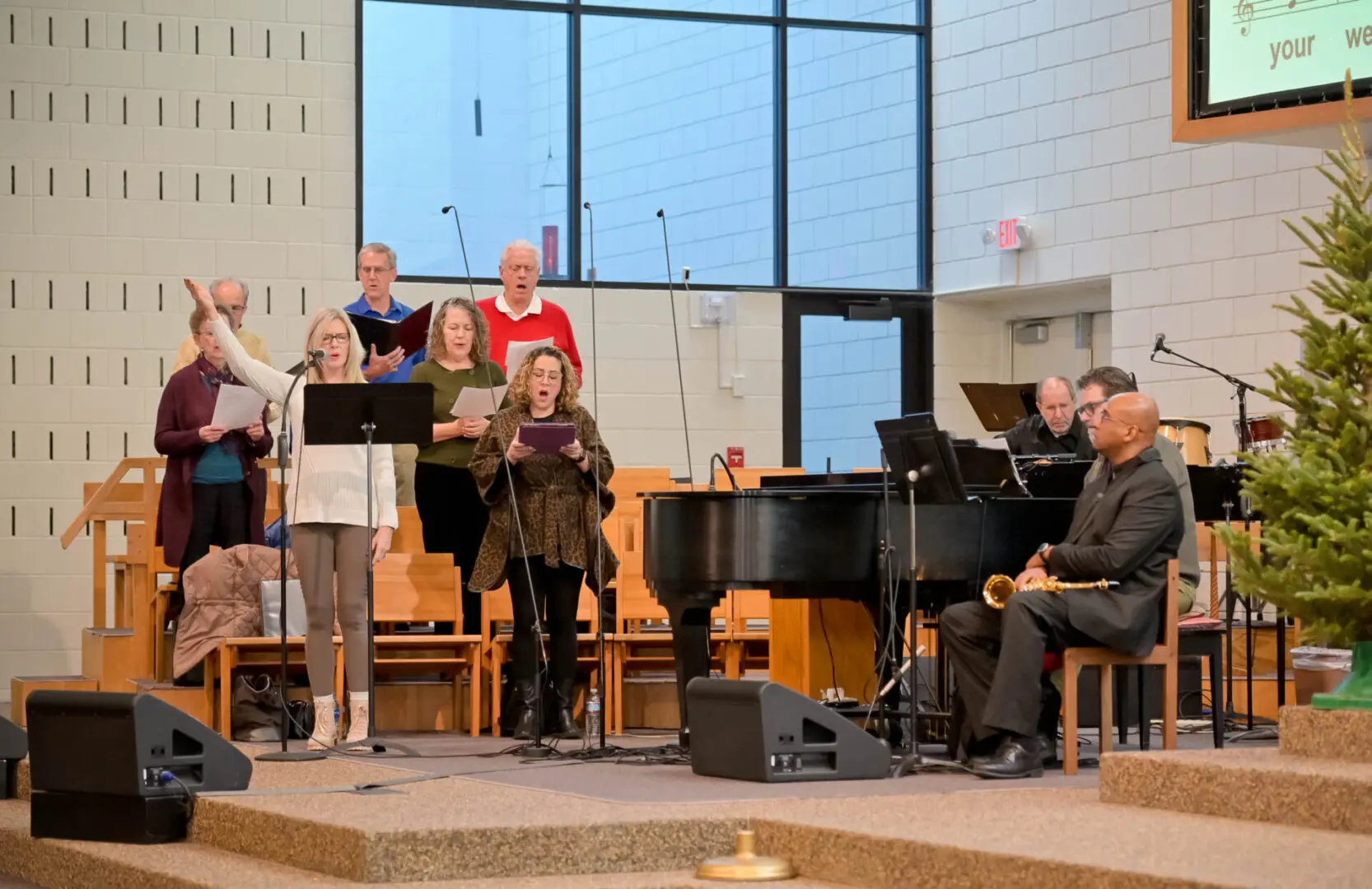 Church choir and pianist perform music.