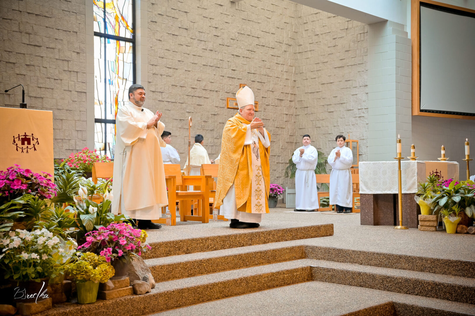 A priest and altar servers in a church.