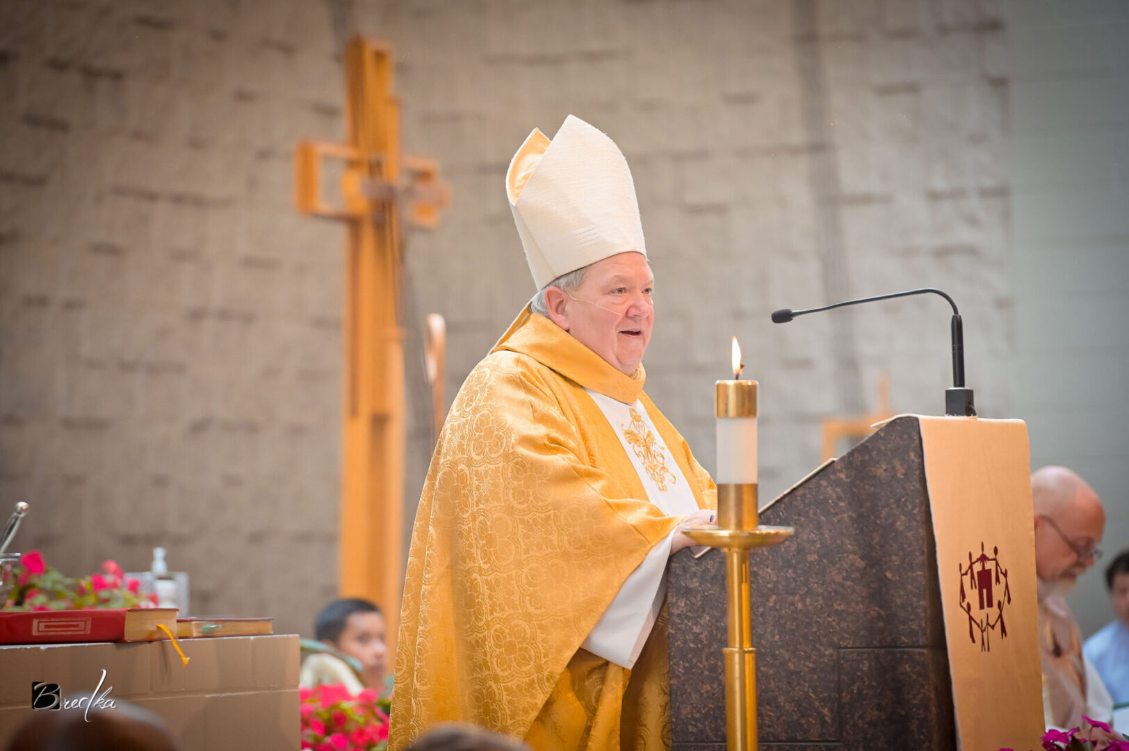 Bishop speaking at a religious ceremony.