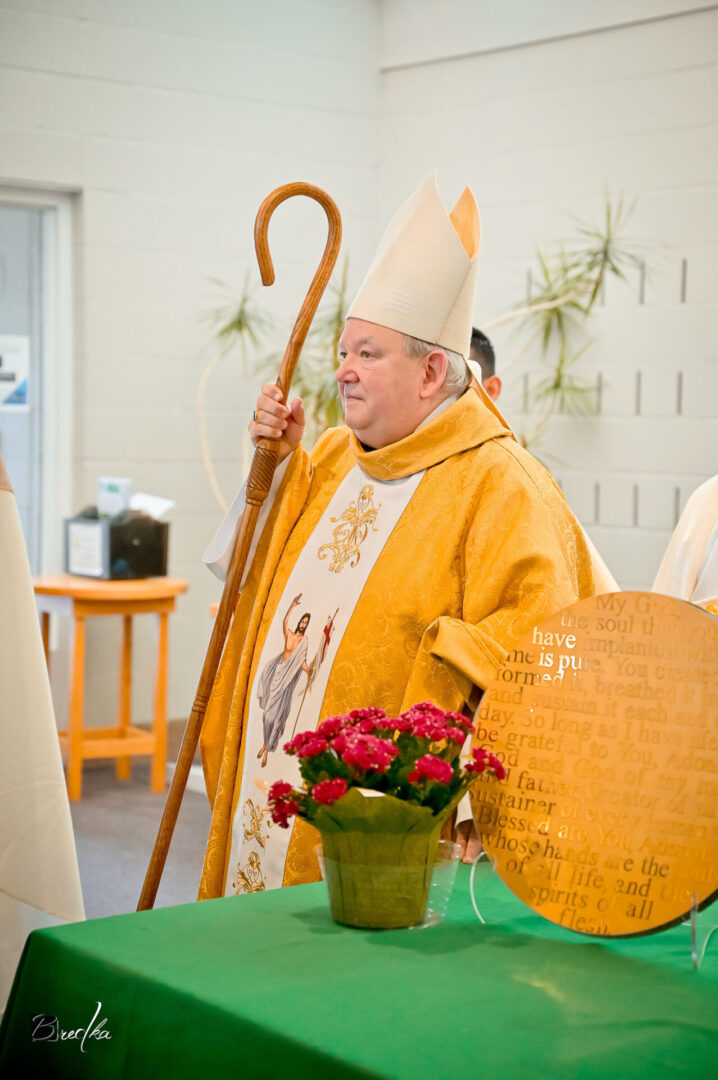 A bishop holding a crosier in a church.