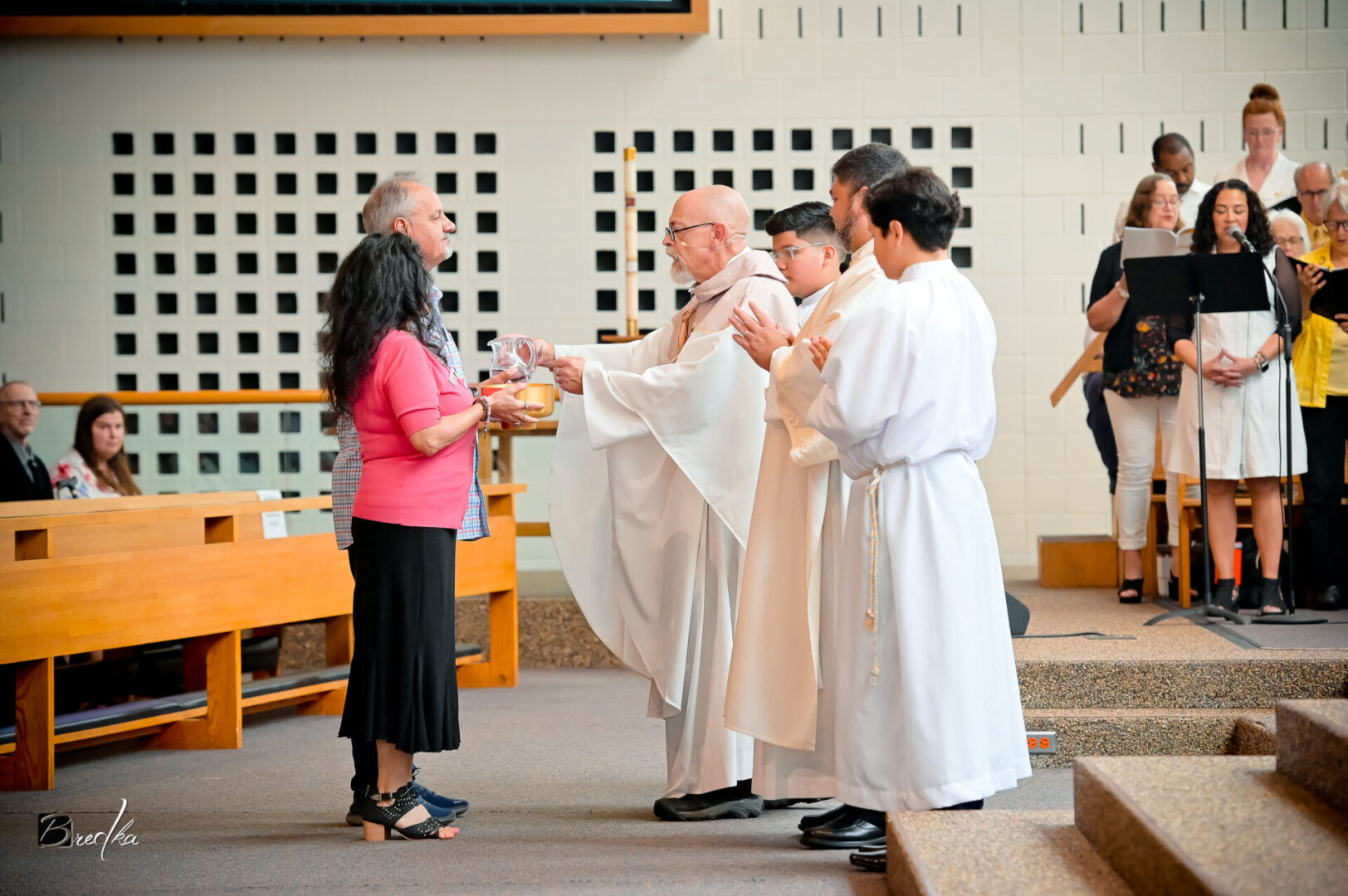 A woman receives communion during a church service.