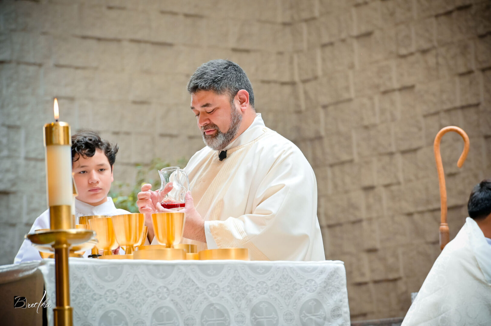 Priest pouring wine during a church service.