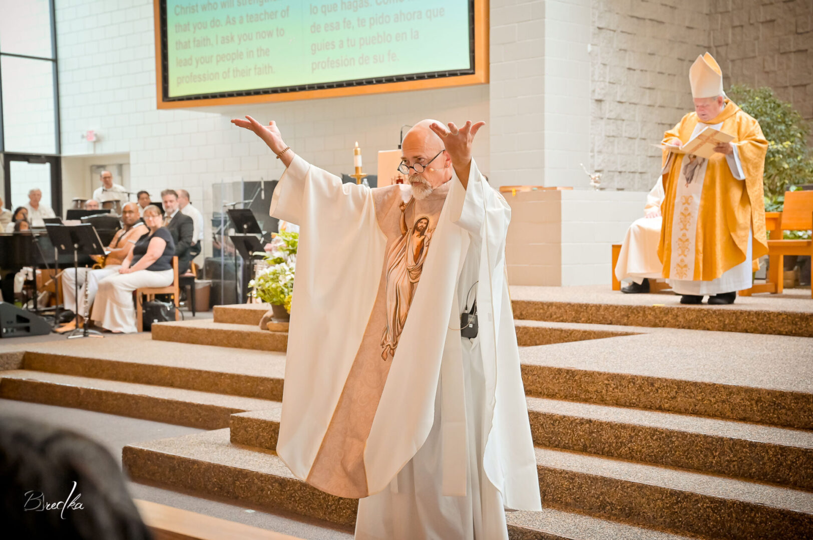 Man in white robe giving a sermon.