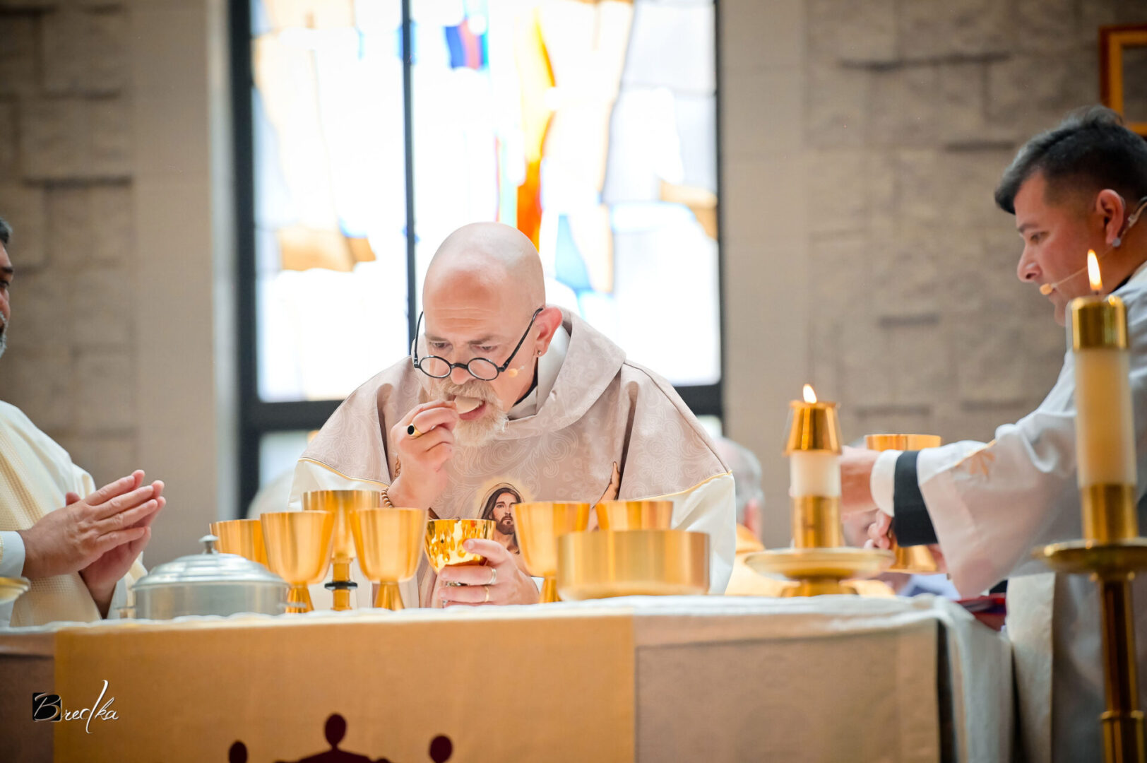 Priest receiving communion during mass.