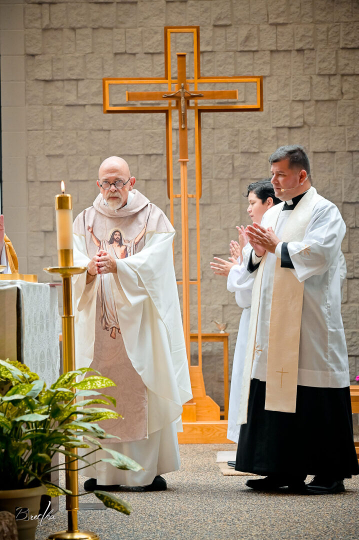 Three priests standing in a church.