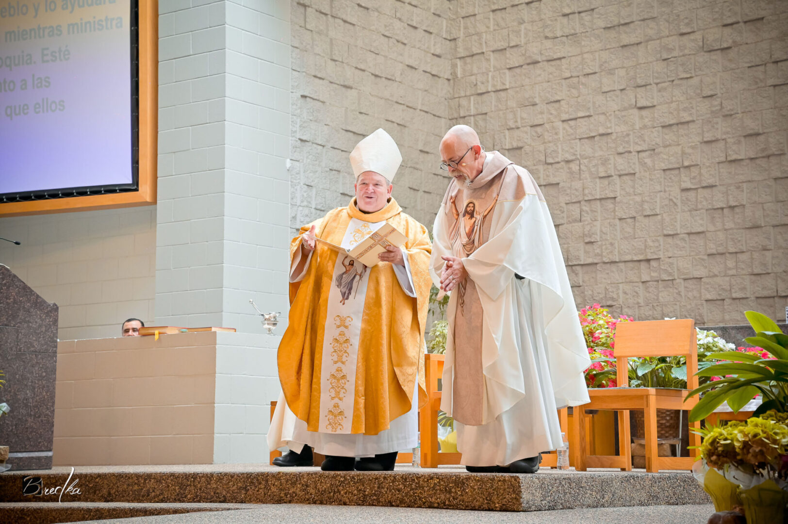 Two priests in robes during a ceremony.
