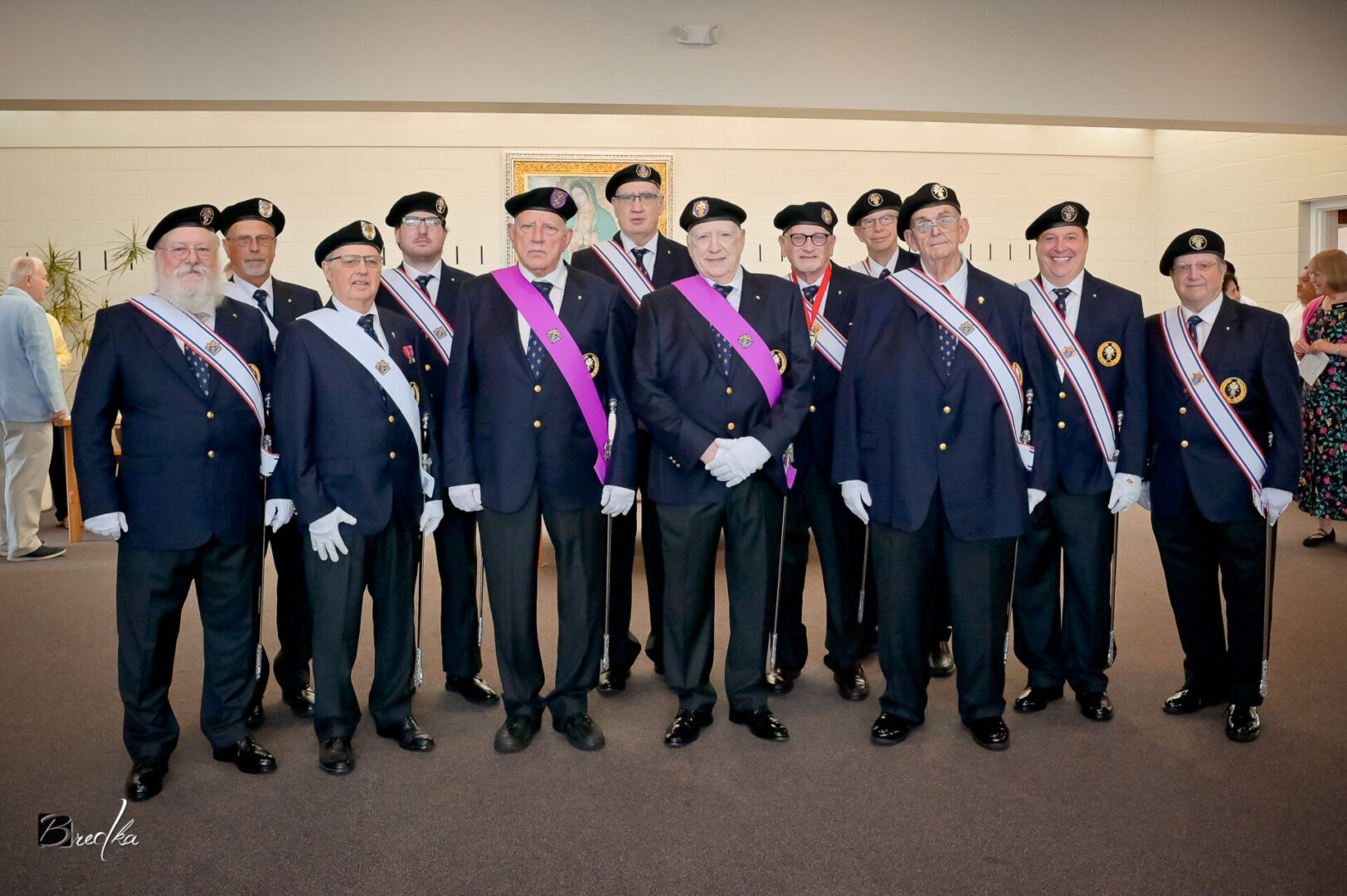 Men in formal attire and sashes