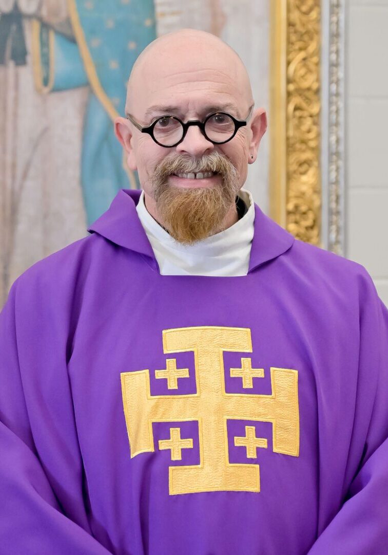 Man in purple robe with cross symbol.